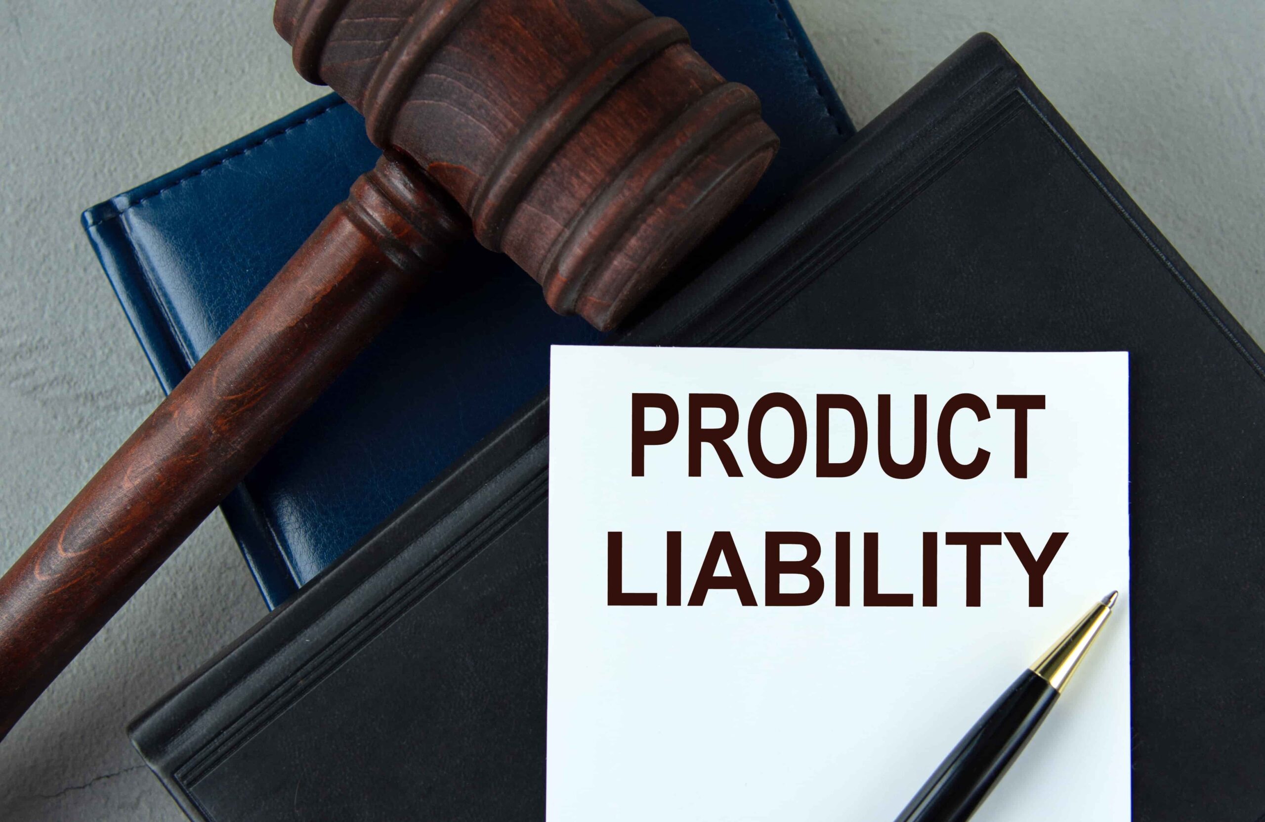 Product liability legal document with judge’s gavel and law books on a desk.
