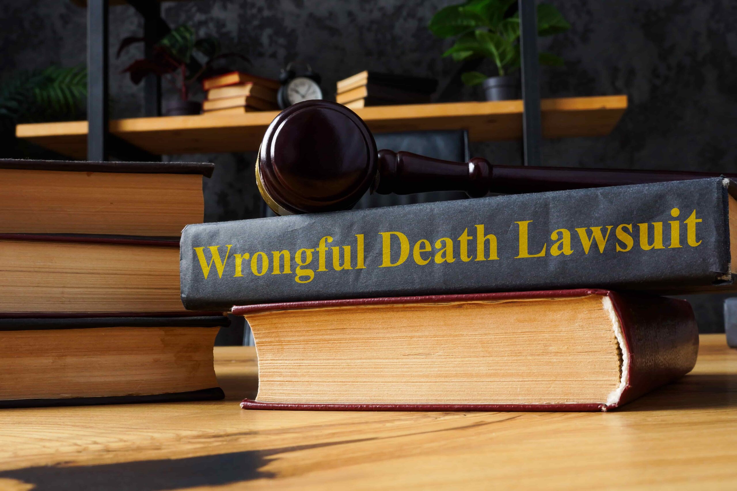 Law books with a judge’s gavel and a volume titled “Wrongful Death Lawsuit,” symbolizing legal claims, wrongful death litigation, and civil justice proceedings.
